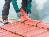 Dachówka ceramiczna w trakcie montażu. Wymiana dachu wymaga pozwolenia, ale efekt końcowy jest wart wysiłku.